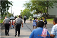 A large group of people walking down street