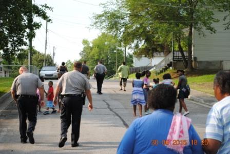 A large group of people walking down street